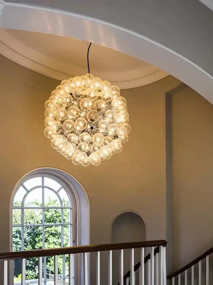 Decorbites led glass bubble chandelier with clear glass bulbs in gold chrome and black emitting warm light