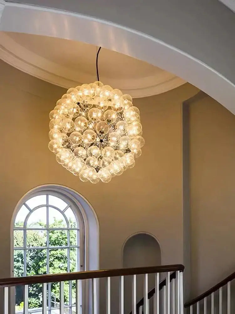 Decorbites led glass bubble chandelier with clear glass bulbs in gold chrome and black emitting warm light