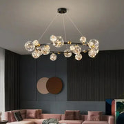 Modern pendant light featuring decorbites led glass bulb with circular gold and black frame and clear globes