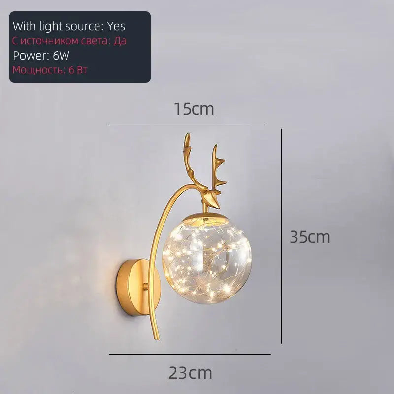 Gold-toned deer-head pendant light with spherical led glass bulb filled with glowing gypsophila string by decorbites led glass