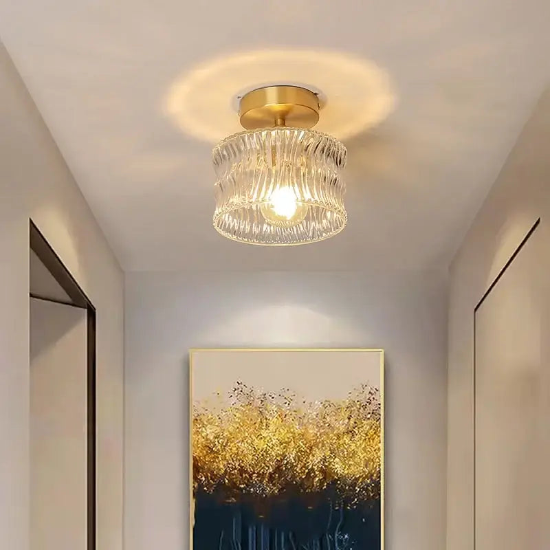 DecorBites led glass ceiling lamp with gold-toned metal base and clear textured glass shade diffusing warm light