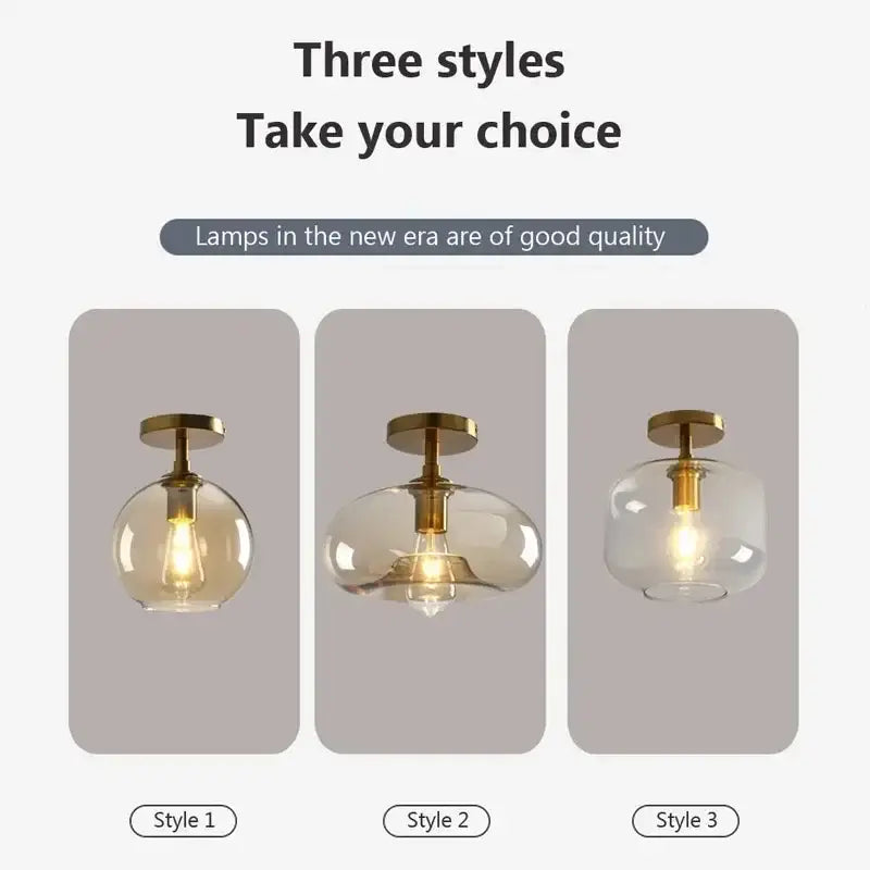 Three modern decorbites led glass pendant ceiling lights with brass fixtures and clear and amber spherical shades