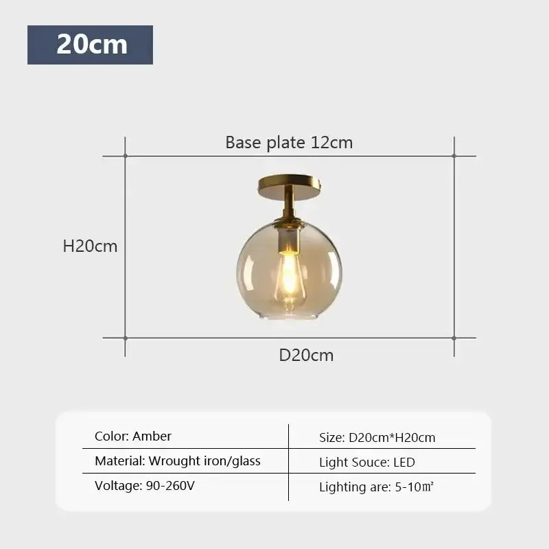 Amber-colored spherical pendant ceiling light with brass base and led glass globe from DecorBites LED Glass collection