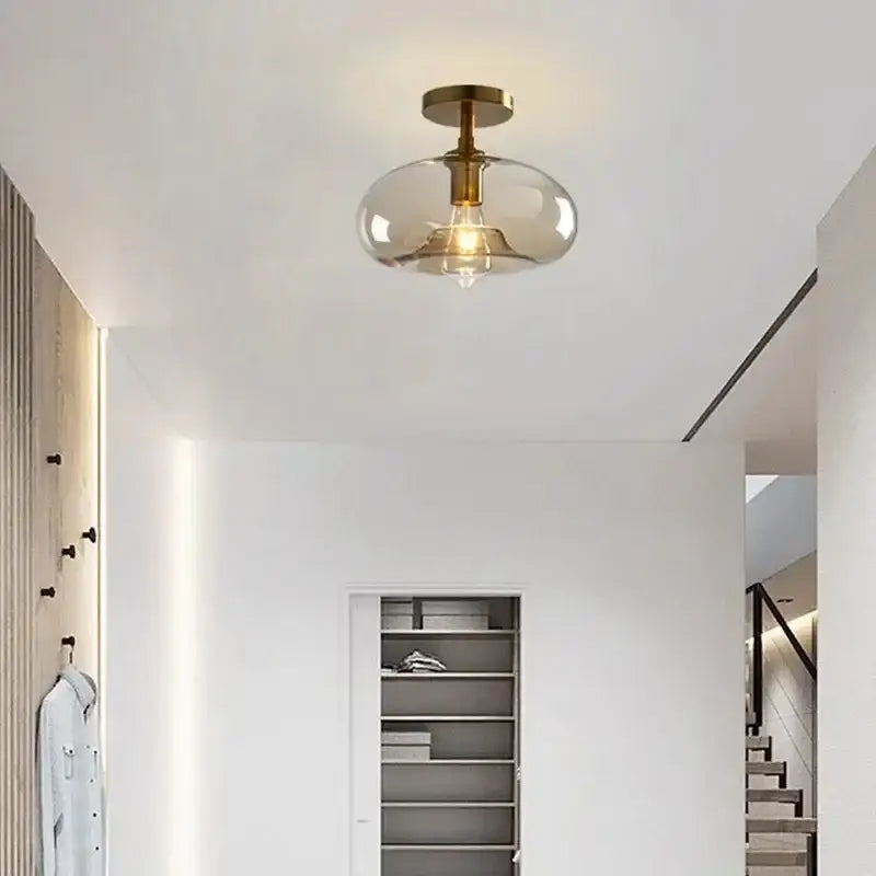 A decorbites led glass ceiling light chandelier with brass metal base and smoke-colored glass dome for modern living spaces