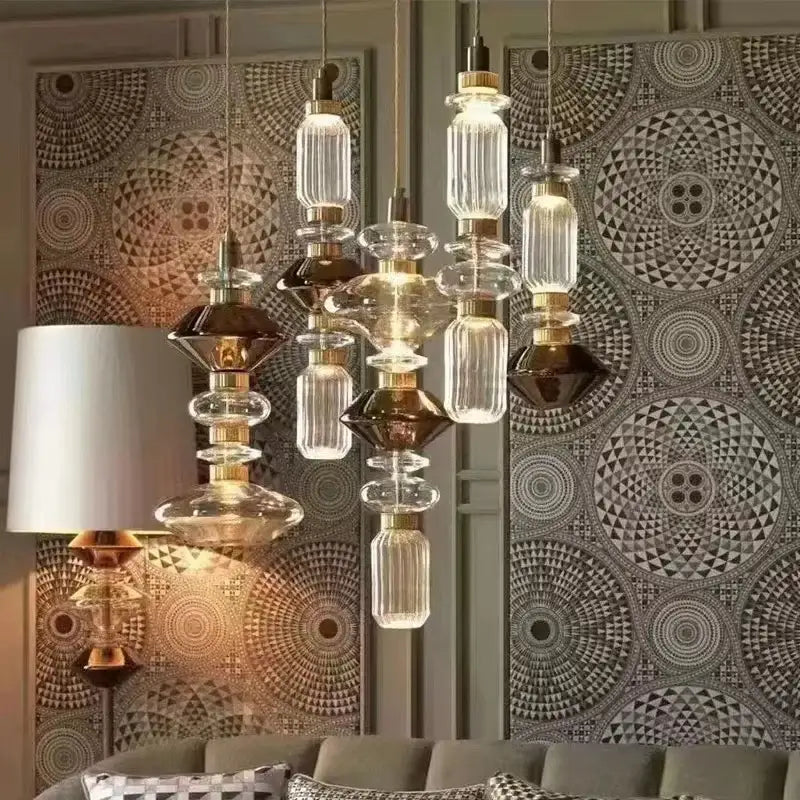 A decorbites led glass chandelier with clear and dark amber glass shades and brass fittings, modern lighting fixture