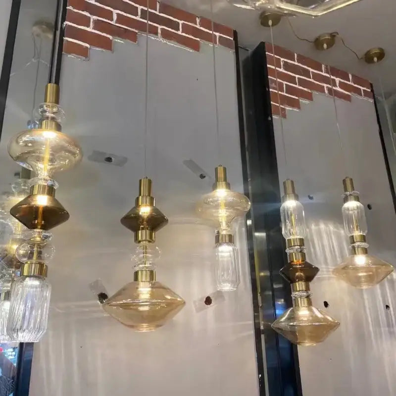 Decorbites led glass chandelier with clear amber glass and brass accents hanging from ceiling with adjustable wire