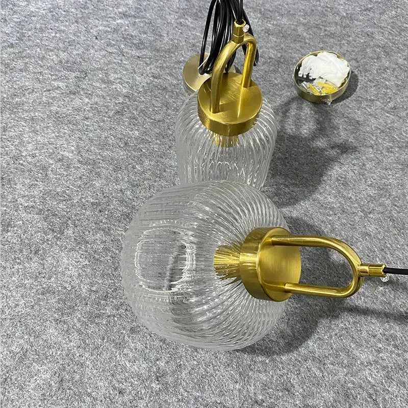 Clear glass pendant lights with gold-toned ribbed fixtures in decorbites led glass chandelier for modern dining rooms
