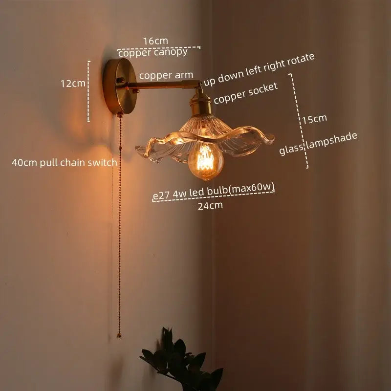 Copper-finished wall sconce with wavy glass lampshade and exposed led bulb featuring pull chain switch for bedroom use