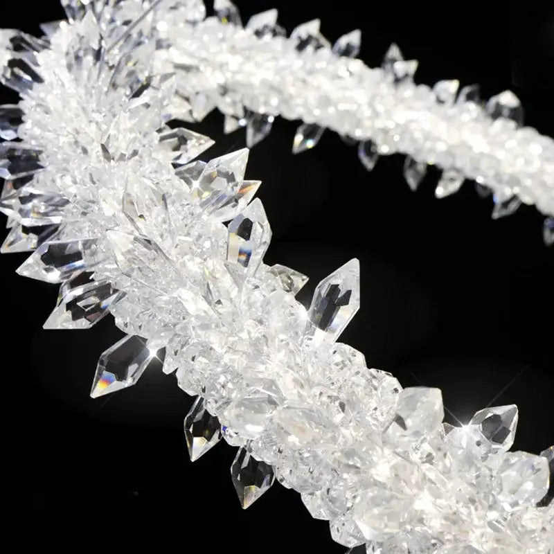 A decorbites led glass crystal chandelier pendant light featuring a clear crystal headband with faceted pointed crystals