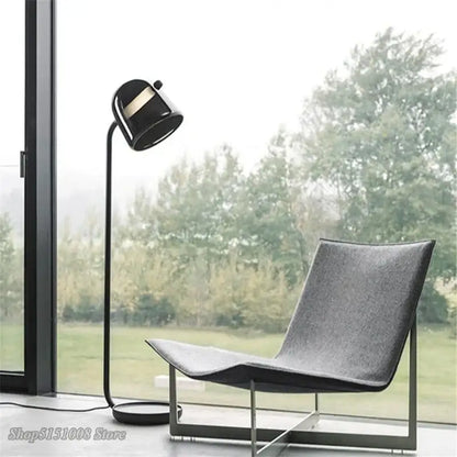 Modern black DecorBites LED glass floor lamp with sleek curved neck and gold-accented matte finish head for living rooms