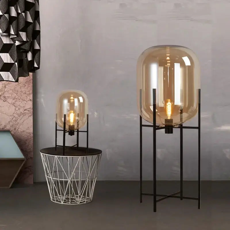 Tall amber glass globe floor lamp with black metal frame from DecorBites led glass floor collection modern minimalist design