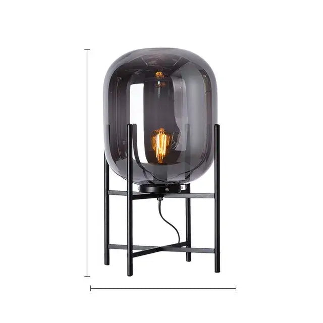 A sleek dark gray smoked glass decorbites led glass floor lamp with black metal frame and exposed filament bulb