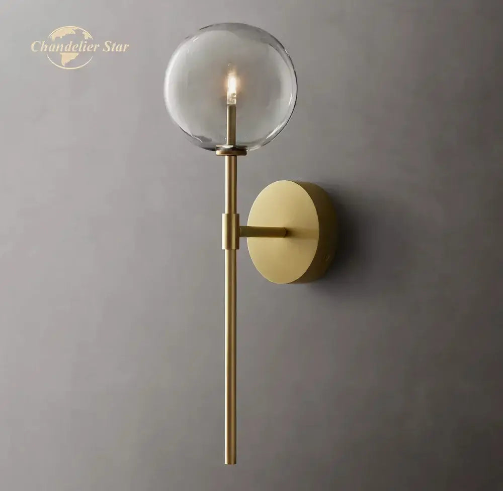 Brass-finished DecorBites LED glass globe wall sconce with clear globe and slender rod for modern indoor lighting