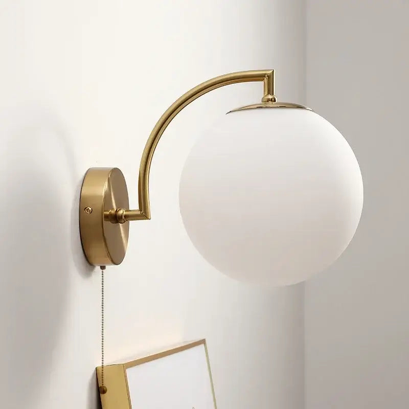 Gold-toned decorbites led glass iron wall light with frosted white spherical shade and pull chain switch for corridor use