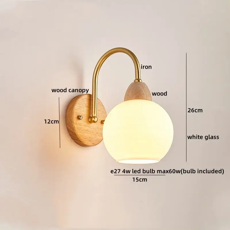 DecorBites™ wall light fixture with brass iron arm, wooden base, and frosted glass globe in warm tones