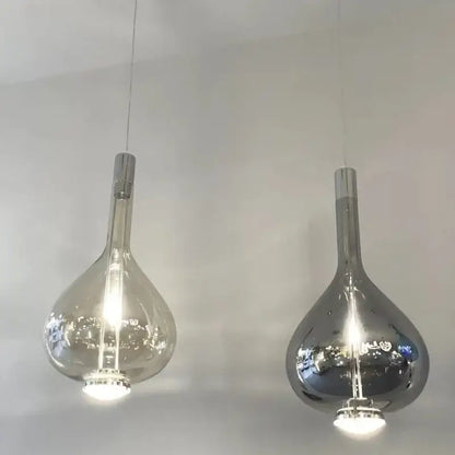 Two modern decorbites led glass pendant chandelier lights with clear and mirrored teardrop glass shades hanging on cords