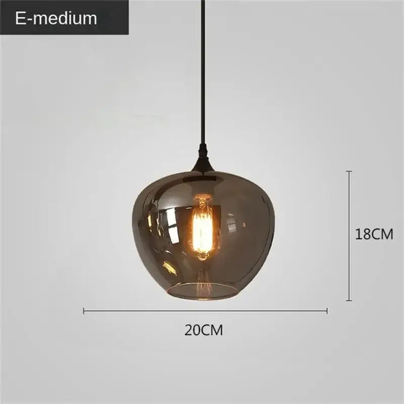 A sleek amber-tinted decorbites led glass pendant chandelier with vintage edison bulb and black cord for kitchen dining bar