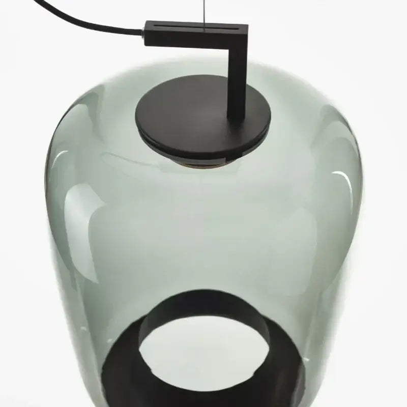 A sleek translucent gray led glass pendant chandelier with matte black metal fixture from DecorBites for dining areas