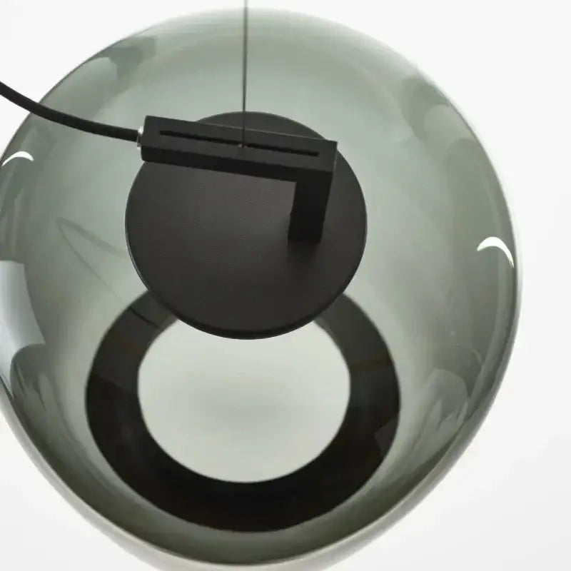 A sleek decorbites led glass pendant chandelier with smoked glass and matte black metal for kitchen and dining use