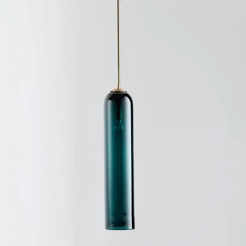 A sleek dark teal glass pendant chandelier with slender brass suspension rod by DecorBites led glass for kitchen decor