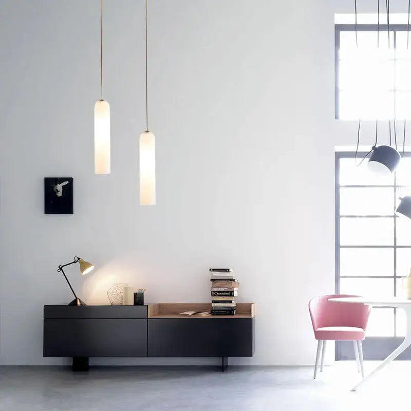 Two slender frosted glass pendant lights hang from the ceiling in the DecorBites LED glass pendant chandelier for kitchen decor