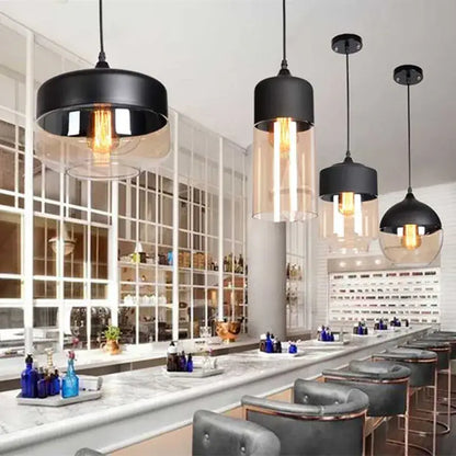 Black metal decorbites led glass pendant lamp with clear glass shades and exposed filament bulbs above a bar area
