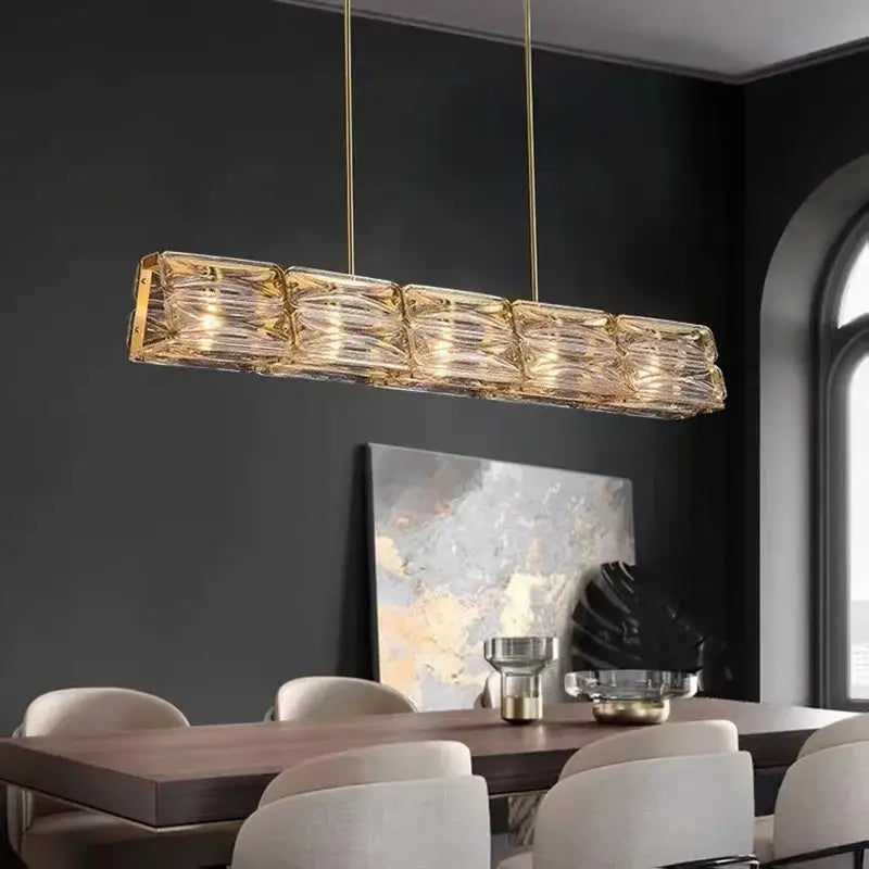Gold-toned decorbites led glass pendant light with textured glass panels and hanging brass chains for kitchen island decor
