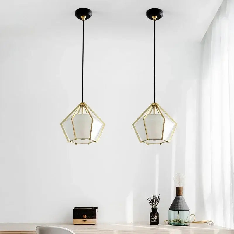 Two modern geometric pendant lights with gold-toned metal frames and white fabric shades by decorbites led glass pendant light