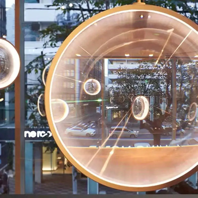 Golden spherical decorbites led glass pendant light with clear glass orbs and warm internal illumination for living room