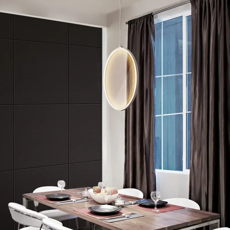 Modern oval pendant light with sleek illuminated frame and soft ambient glow by decorbites led glass pendant for living room