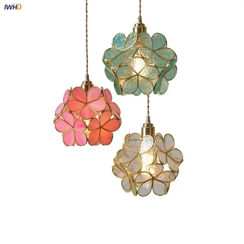 Three decorbites led glass pendant lights with flower-shaped translucent petals in pink teal and clear on gold chains