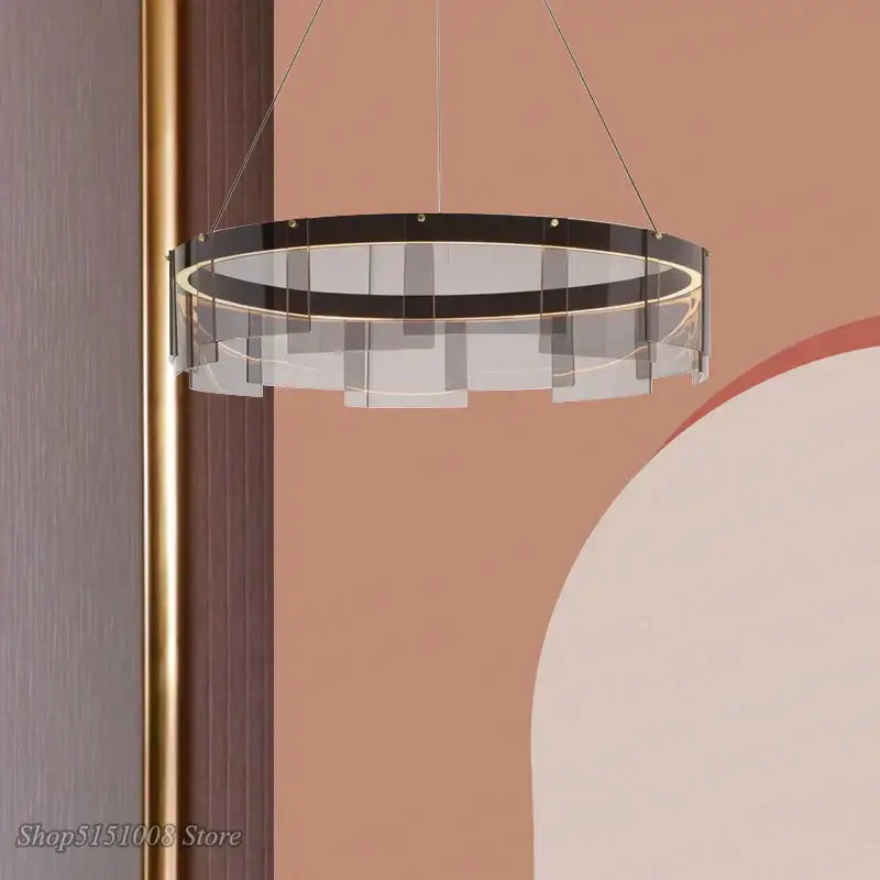 Modern circular pendant lights with a sleek black iron frame and warm led accents by DecorBites LED glass ring collection