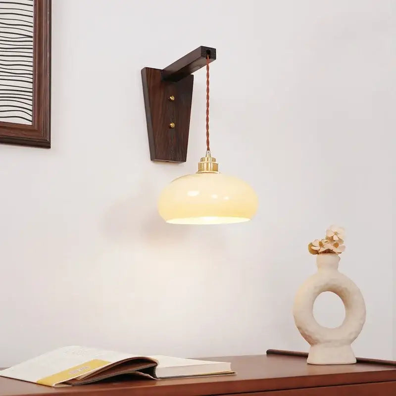 Warm cream-colored decorbites led glass sconce wall lamp with brass fixture and dark wood bracket for nordic stair lighting