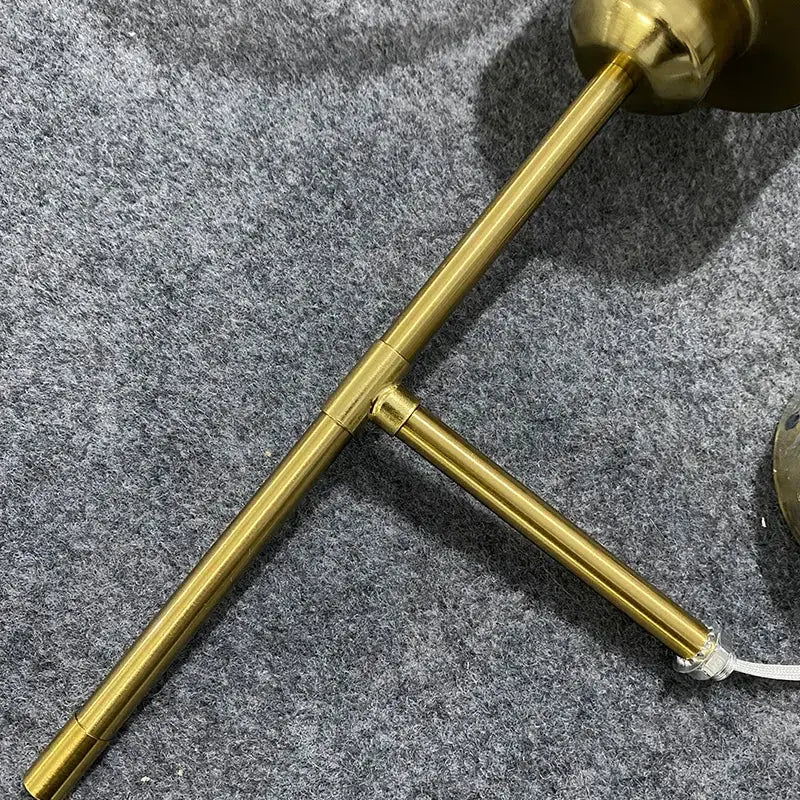 Brass-finished t-shaped wall lamp base with sleek polished metal rods for decorbites led glass wall lamp design
