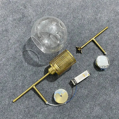 Gold-toned brass DecorBites led glass wall lamp with clear glass globe shade and perforated metal diffuser for modern decor