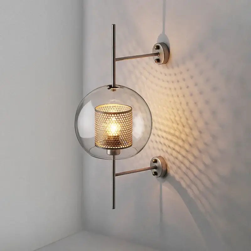 Modern DecorBites™ led glass wall lamp with clear globe, gold honeycomb mesh shade, and sleek metallic arms for bedroom decor