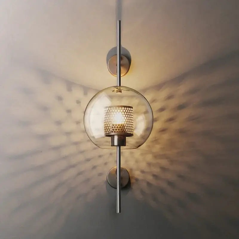 Modern spherical glass wall lamp with brass honeycomb shade and brushed metal accents for DecorBites led glass wall lighting