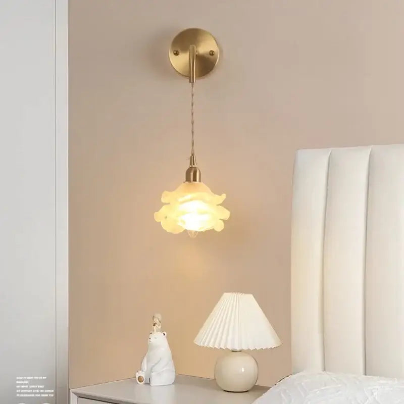Gold-toned decorbites led glass wall lamp with petal-shaped frosted glass shade for modern bedroom or vanity use