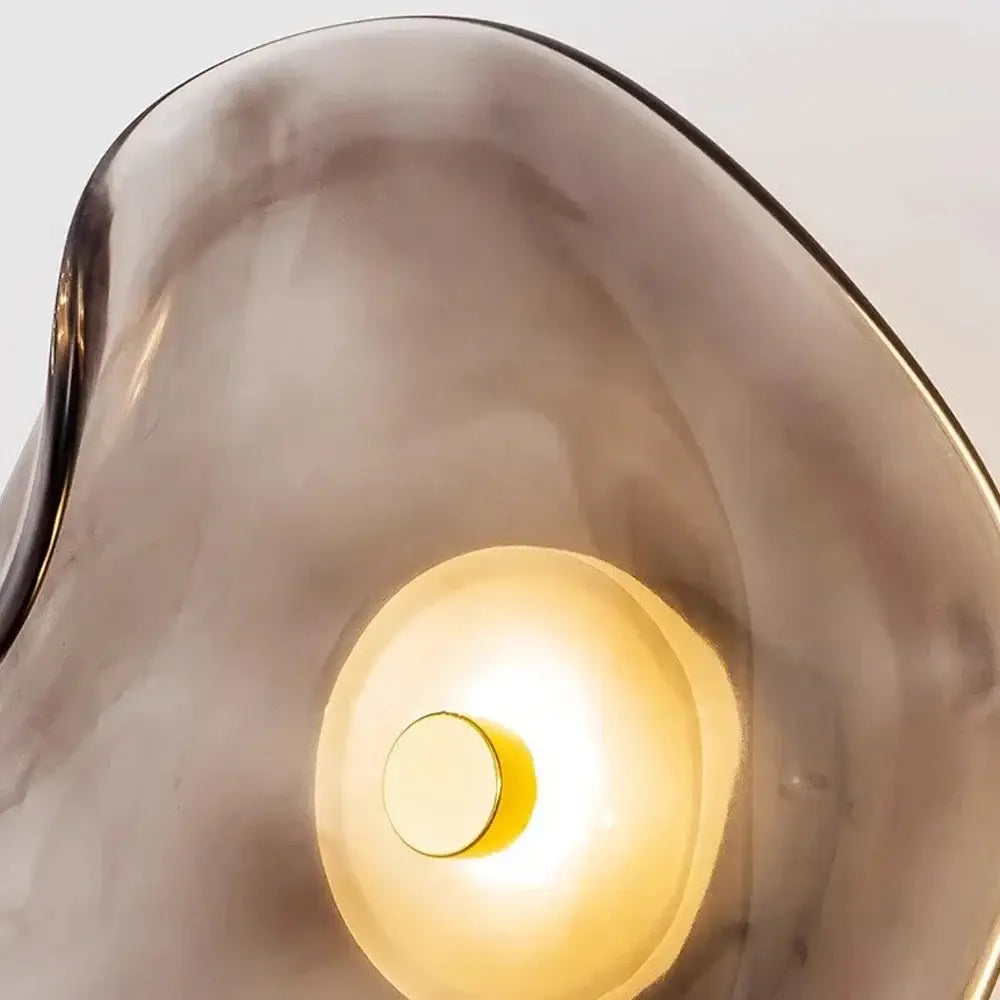 Decorbites™ led glass wall lamp with a sleek translucent smoke-gray glass shade and warm golden light emission