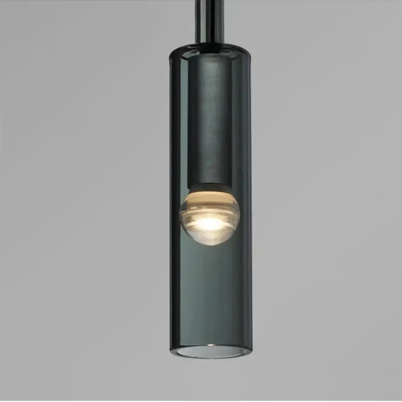 A sleek dark smoked glass decorbites led glass wall lamp with a warm bulb for modern indoor lighting
