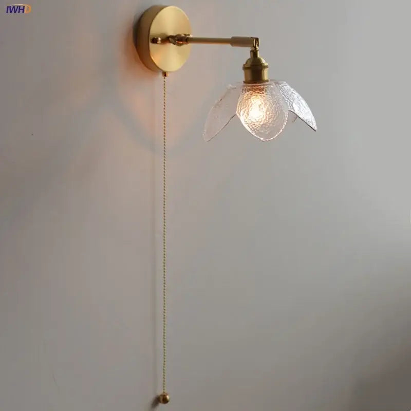Gold-toned DecorBites™ LED wall light fixture with textured glass flower shade and adjustable pull-chain switch for living room use