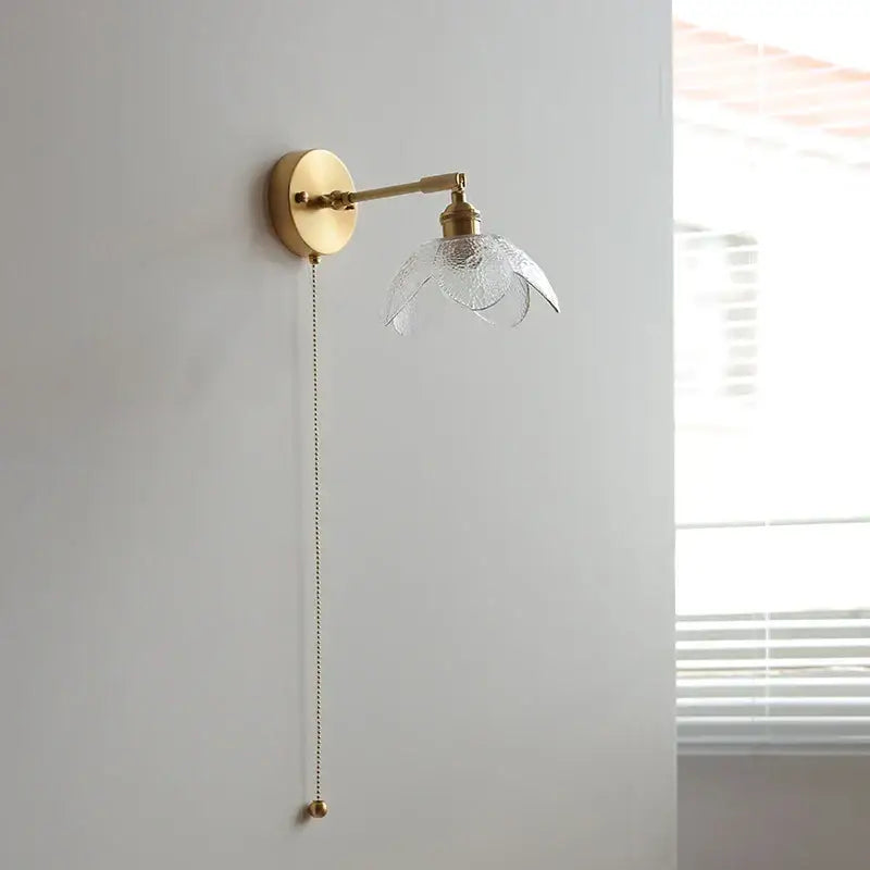 DecorBites™ brass wall light fixture with textured clear glass shade and elegant pull chain for modern living room