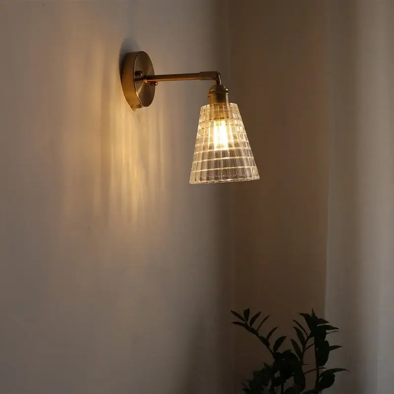 Brass-finished decorbites led glass wall light with textured clear glass shade for modern bedroom and living room decor