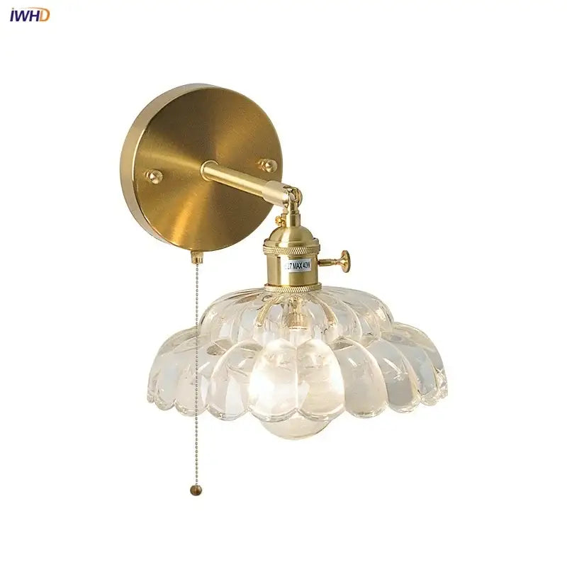 Gold-finished decorbites led glass wall sconce with clear petal-shaped glass shade and adjustable arm for bedside lighting