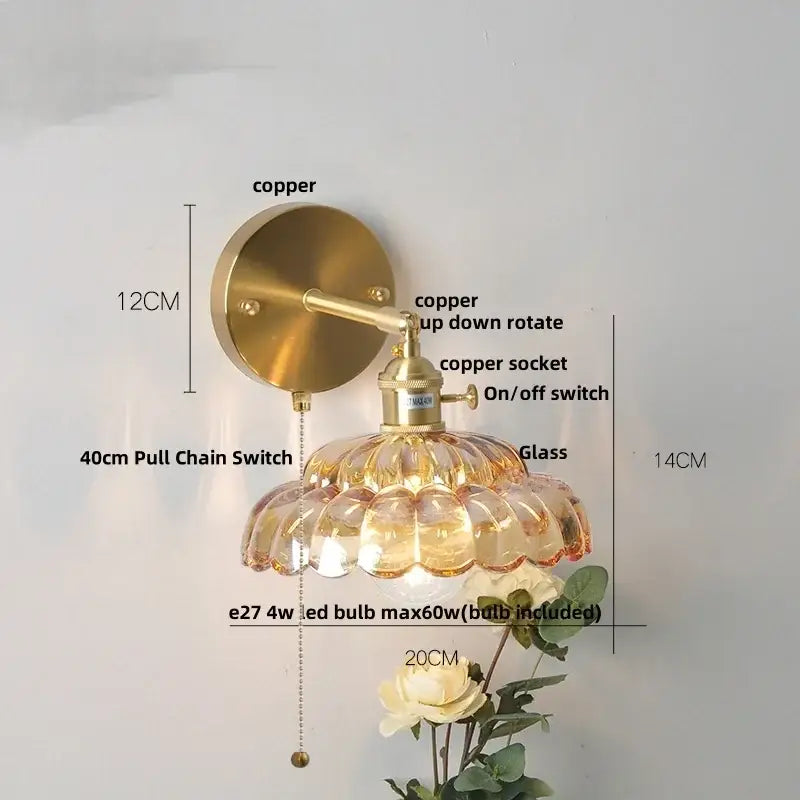 Brass-finished decorbites led glass wall light with scalloped amber glass shade and copper socket for bedside use