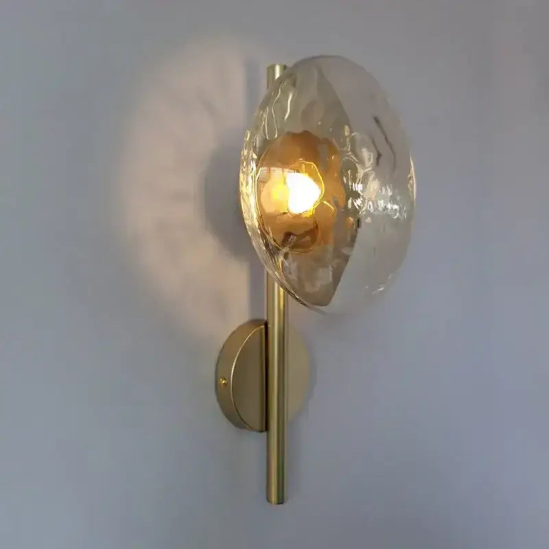 Gold-toned decorbites led glass wall sconce with hammered glass dome diffuser for living room background lighting