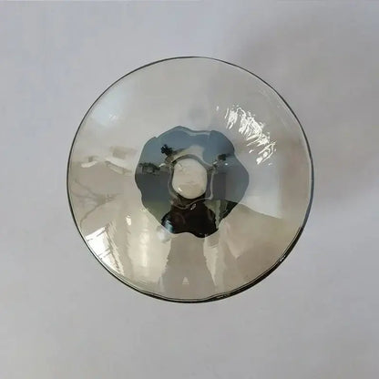 A translucent gray glass bowl with a smooth rim and textured interior in DecorBites LED glass wall sconce for living room