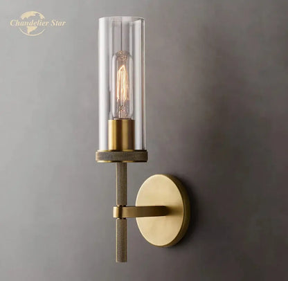 Brass-finished decorbites led glass wall sconce with clear glass cylinder and exposed filament bulb for indoor use