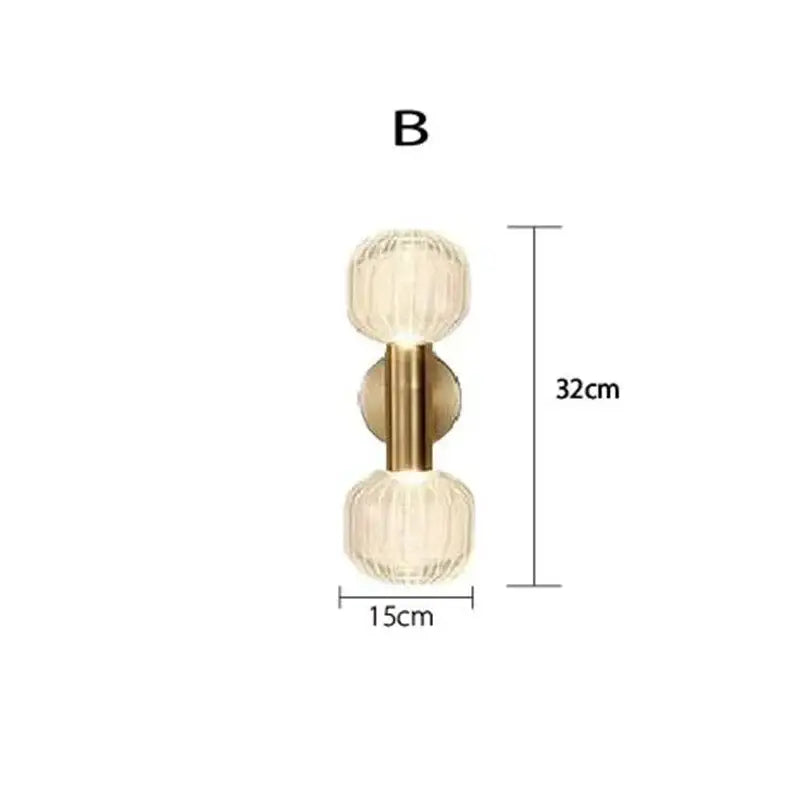 Gold-toned DecorBites™ LED glass wall sconces featuring two faceted translucent glass globes for home lighting