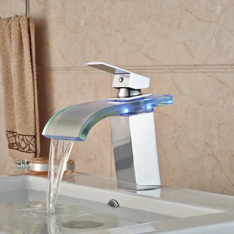 Modern chrome decorbites led glass basin faucet with curved spout emitting blue led glass waterfall light